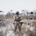 A Ukrainian soldier amid a swarm of AI-enabled drones at a Ready-for-Deployment demonstration.