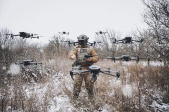 A Ukrainian soldier amid a swarm of AI-enabled drones at a Ready-for-Deployment demonstration.