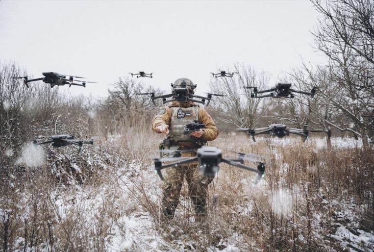 A Ukrainian soldier amid a swarm of AI-enabled drones at a Ready-for-Deployment demonstration.